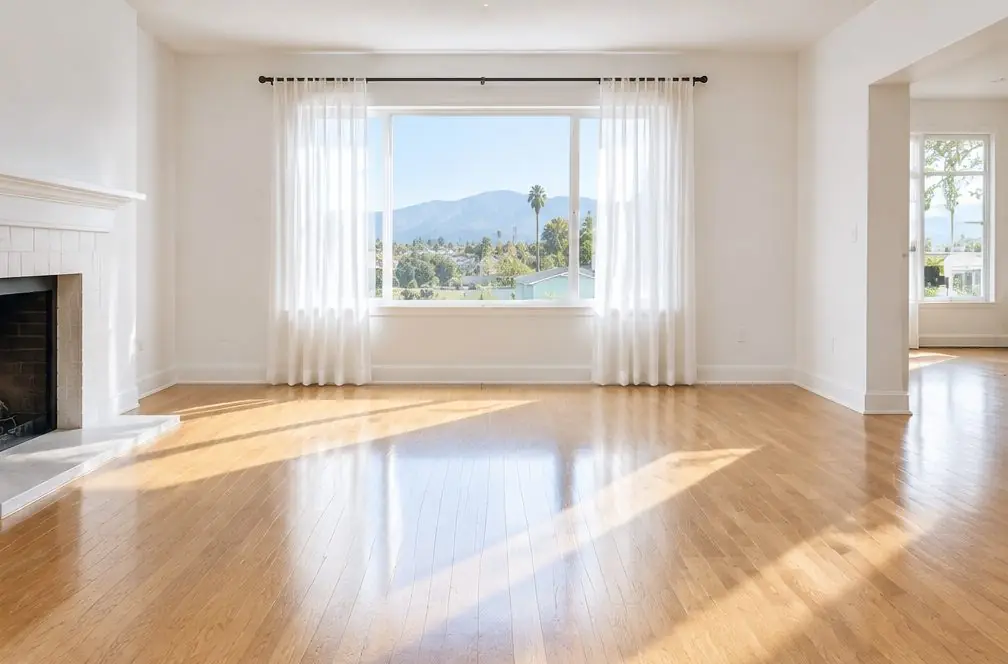 Illustration: a refinished honey-toned oak floor in an older Ontario, CA bungalow living room, a window with sheer curtains and afternoon light across the boards