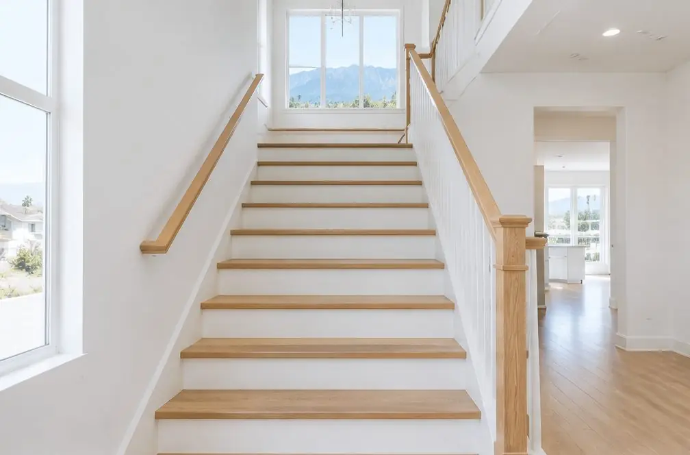 Illustration: a straight staircase in an Ontario, CA two-story home with oak treads, white risers and a continuous handrail, a landing window above